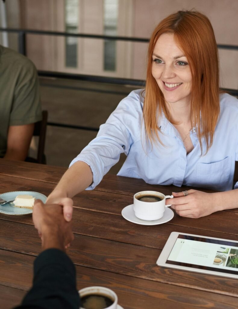 Photo of Woman Handshaking With Another Person